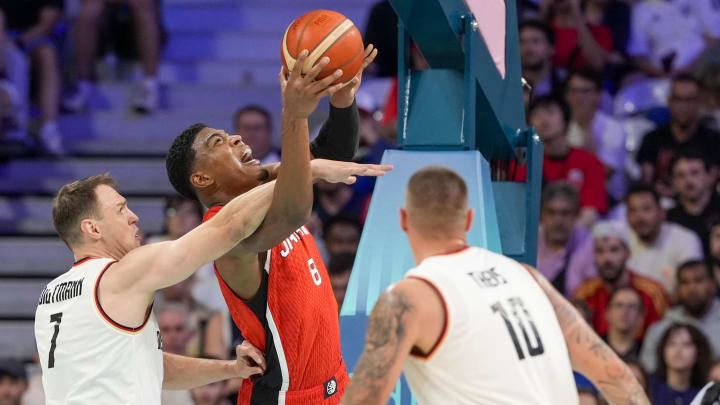 Jul 27, 2024; Villeneuve-d'Ascq, France; Japan small forward Rui Hachimura (8) is guarded by Germany center Johannes Voigtmann (7) and Germany power forward Daniel Theis (10) under the basket during the Paris 2024 Olympic Summer Games at Stade Pierre-Mauroy.