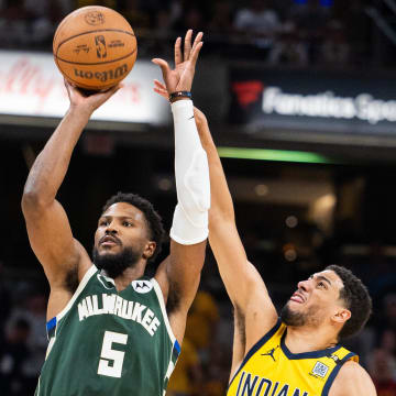 Apr 28, 2024; Indianapolis, Indiana, USA; Milwaukee Bucks guard Malik Beasley (5) shoots the ball while Indiana Pacers guard Tyrese Haliburton (0) defends during game four of the first round for the 2024 NBA playoffs at Gainbridge Fieldhouse. Mandatory Credit: Trevor Ruszkowski-USA TODAY Sports