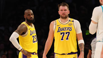 Feb 19, 2025; Los Angeles, California, USA; Los Angeles Lakers forward LeBron James (23) and guard Luka Doncic (77) during the second quarter against the Charlotte Hornets at Crypto.com Arena. Mandatory Credit: Jason Parkhurst-Imagn Images