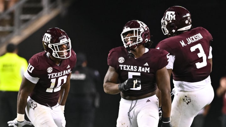 Sep 2, 2023; College Station, Texas, USA; Texas A&M Aggies defensive back Jacoby Mathews (2), defensive lineman Fadil Diggs (10) and defensive lineman Shemar Turner (5) react to a tackle for a loss during the fourth quarter against the New Mexico Lobos at Kyle Field. Mandatory Credit: Maria Lysaker-USA TODAY Sports