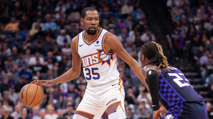 Apr 12, 2024; Sacramento, California, USA; Phoenix Suns forward Kevin Durant (35) controls the ball against Sacramento Kings guard Keon Ellis (23) 
