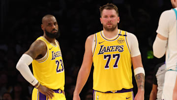 Feb 19, 2025; Los Angeles, California, USA; Los Angeles Lakers forward LeBron James (23) and guard Luka Doncic (77) during the second quarter against the Charlotte Hornets at Crypto.com Arena. Mandatory Credit: Jason Parkhurst-Imagn Images