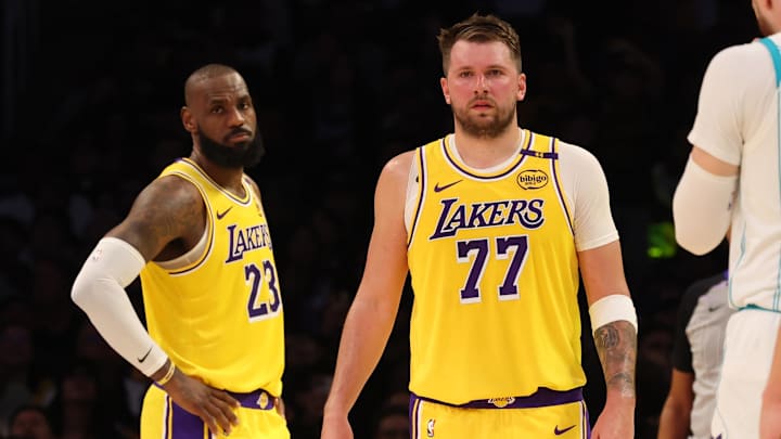 Feb 19, 2025; Los Angeles, California, USA; Los Angeles Lakers forward LeBron James (23) and guard Luka Doncic (77) during the second quarter against the Charlotte Hornets at Crypto.com Arena. Mandatory Credit: Jason Parkhurst-Imagn Images
