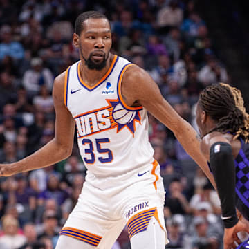 Apr 12, 2024; Sacramento, California, USA; Phoenix Suns forward Kevin Durant (35) controls the ball against Sacramento Kings guard Keon Ellis (23) during the second quarter at Golden 1 Center. Mandatory Credit: Ed Szczepanski-Imagn Images