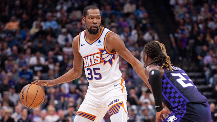 Apr 12, 2024; Sacramento, California, USA; Phoenix Suns forward Kevin Durant (35) controls the ball against Sacramento Kings guard Keon Ellis (23) during the second quarter at Golden 1 Center. Mandatory Credit: Ed Szczepanski-Imagn Images