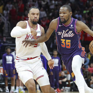 Feb 23, 2024; Houston, Texas, USA; Phoenix Suns forward Kevin Durant (35) drives with the ball as Houston Rockets forward Dillon Brooks (9) defends during the fourth quarter at Toyota Center. Mandatory Credit: Troy Taormina-USA TODAY Sports