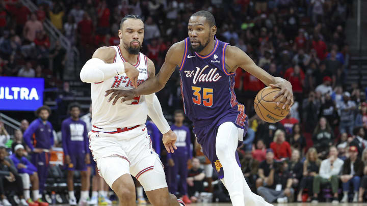 Feb 23, 2024; Houston, Texas, USA; Phoenix Suns forward Kevin Durant (35) drives with the ball as Houston Rockets forward Dillon Brooks (9) defends during the fourth quarter at Toyota Center. Mandatory Credit: Troy Taormina-USA TODAY Sports