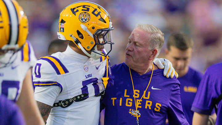 Oct 11, 2025; Baton Rouge, Louisiana, USA;  LSU Tigers head coach Brian Kelly talks to wide receiver Zavion Thomas (0) against the South Carolina Gamecocks during the first half at Tiger Stadium. Mandatory Credit: Stephen Lew-Imagn Images