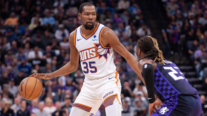 Apr 12, 2024; Sacramento, California, USA; Phoenix Suns forward Kevin Durant (35) controls the ball against Sacramento Kings guard Keon Ellis (23) during the second quarter at Golden 1 Center. Mandatory Credit: Ed Szczepanski-USA TODAY Sports