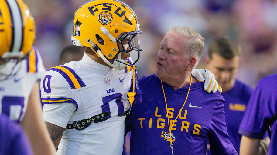 LSU coach Brian Kelly talks to wide receiver Zavion Thomas.