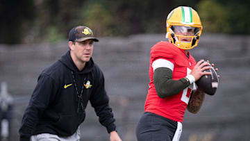 Oregon quarterback Dillon Gabriel throws out a pass as offensive coordinator Will Stein during practice with the Oregon Ducks on Tuesday, Aug. 27, 2024, at the Hatfield-Dowlin Complex in Eugene, Ore.