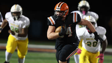 Hoover’s Jack Ziarko runs a first half interception for a gain in the first half against Columbus Northland in a Division II, Region 7 first-round playoff game at Hoover, Friday, October. 31, 2025.