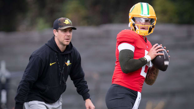 Oregon quarterback Dillon Gabriel throws out a pass as offensive coordinator Will Stein during practice with the Oregon Ducks