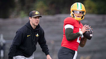Oregon quarterback Dillon Gabriel throws out a pass as offensive coordinator Will Stein during practice with the Oregon Ducks on Tuesday, Aug. 27, 2024, at the Hatfield-Dowlin Complex in Eugene, Ore.