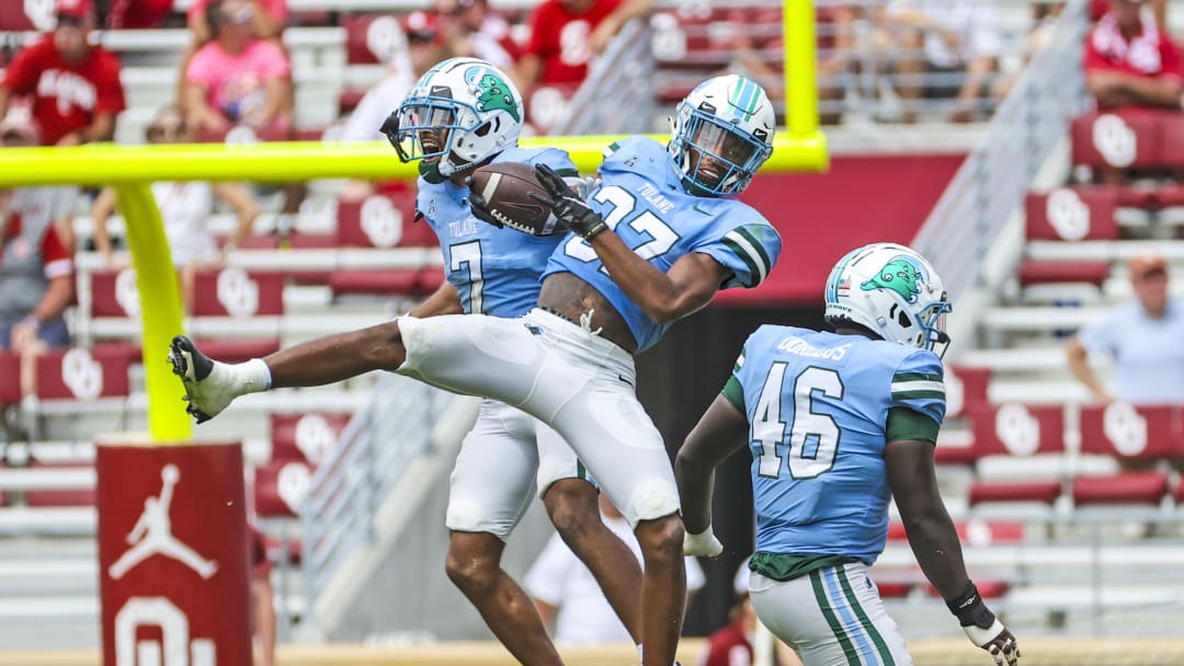 Sep 4, 2021; Norman, Oklahoma, USA;  Tulane Green Wave safety Macon Clark (37) celebrates with defensive back Lance Robinson (7) and defensive lineman JoJo Dorceus (46) after making an interception during the fourth quarter against the Oklahoma Soonersat Gaylord Family-Oklahoma Memorial Stadium. Mandatory Credit: 