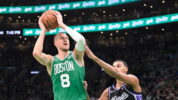 Apr 5, 2024; Boston, Massachusetts, USA; Boston Celtics center Kristaps Porzingis (8) shoots the ball  against Sacramento Kings forward Keegan Murray (13) during the first half at TD Garden. Mandatory Credit: Eric Canha-USA TODAY Sports