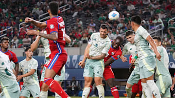 Mexico midfielder Luis Chavez goes for the header  during...