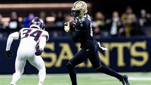 New Orleans Saints wide receiver Chris Olave (12) catches a pass against Atlanta Falcons cornerback Clark Phillips III (34) 