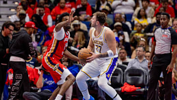 Nov 14, 2025; New Orleans, Louisiana, USA;  Los Angeles Lakers forward/guard Luka Dončić (77) dribbles against New Orleans Pelicans forward Herbert Jones (2) during the second half at Smoothie King Center. Mandatory Credit: Stephen Lew-Imagn Images