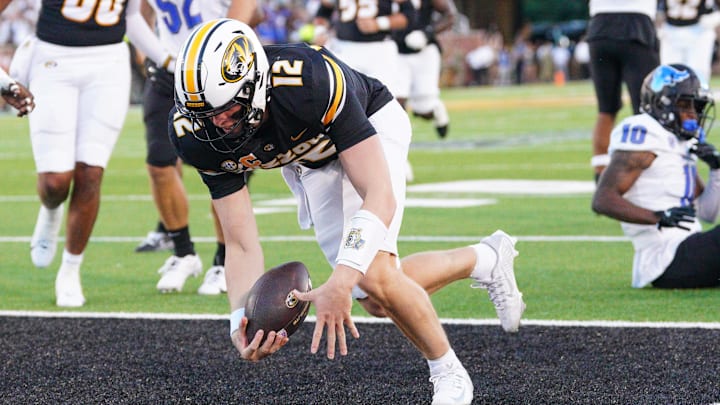 Sep 7, 2024; Columbia, Missouri, USA; Missouri Tigers quarterback Brady Cook (12) runs in for a touchdown against the Buffalo Bulls during the first half at Faurot Field at Memorial Stadium. Mandatory Credit: Denny Medley-Imagn Images