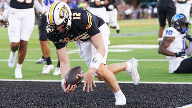 Missouri Tigers quarterback Brady Cook (12) runs in for a touchdown against the Buffalo Bulls during the first half at Faurot