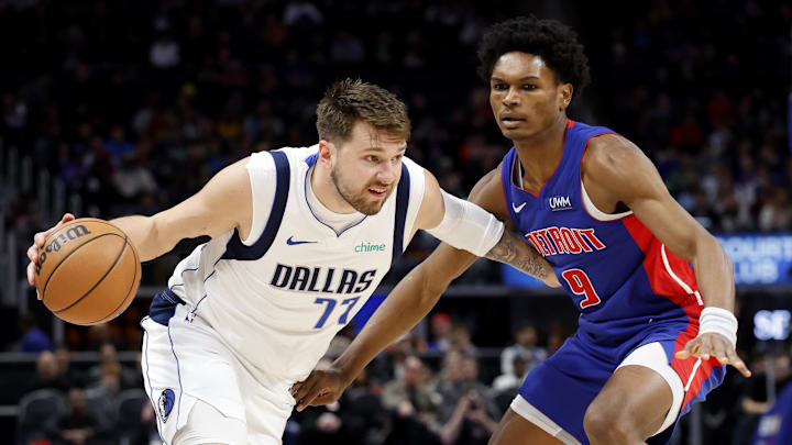 Mar 9, 2024; Detroit, Michigan, USA;  Dallas Mavericks guard Luka Doncic (77) dribbles against Detroit Pistons forward Ausar Thompson (9) in the first half at Little Caesars Arena. Mandatory Credit: Rick Osentoski-Imagn Images