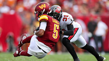 Sep 8, 2024; Tampa, Florida, USA; Washington Commanders quarterback Jayden Daniels (5) is hit by Tampa Bay Buccaneers safety Antoine Winfield Jr. (31) in the second quarter at Raymond James Stadium. Mandatory Credit: Nathan Ray Seebeck-Imagn Images