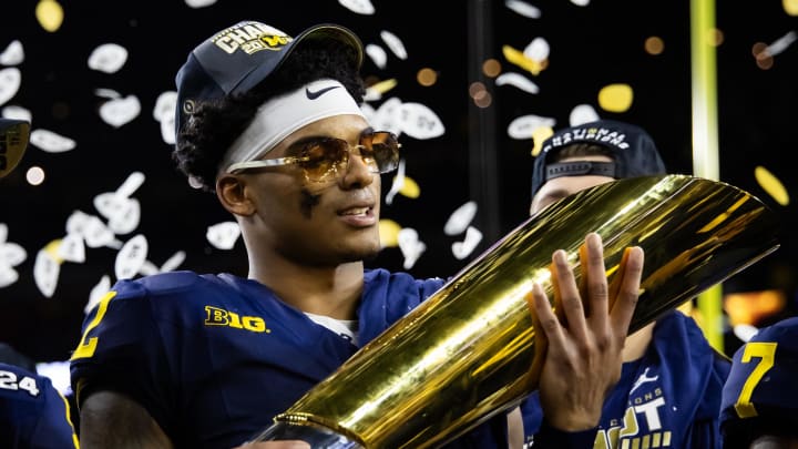 Jan 8, 2024; Houston, TX, USA; Michigan Wolverines defensive back Will Johnson (2) celebrates with the championship trophy after defeating the Washington Huskies during the 2024 College Football Playoff national championship game at NRG Stadium. Mandatory Credit: Mark J. Rebilas-USA TODAY Sports