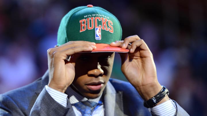 June 28, 2012; Newark, NJ, USA; John Henson (North Carolina) puts on a cap after being introduced as the number fourteen overall pick to the Milwaukee Bucks during the 2012 NBA Draft at the Prudential Center.  Mandatory Credit: Jerry Lai-Imagn Images