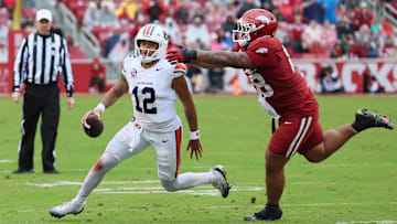 Oct 25, 2025; Fayetteville, Arkansas, USA; Auburn Tigers quarterback Ashton Daniels (12) rushes during the third quarter as Arkansas Razorbacks defensive tackle Danny Saili (88) defends at Donald W. Reynolds Razorback Stadium. Auburn won 33-24. Mandatory Credit: Nelson Chenault-Imagn Images