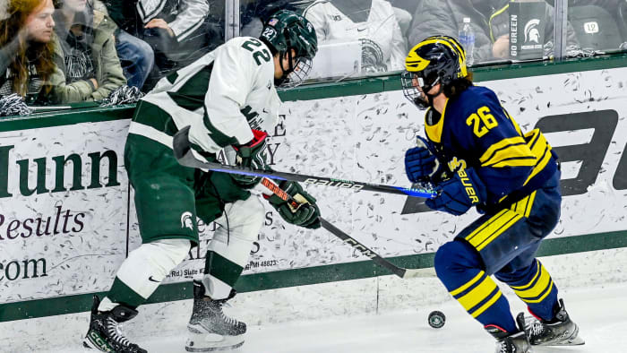 Michigan State's Isaac Howard, left, and Michigan's Seamus Casey go after the puck during the second period on Friday, Jan. 19, 2024, at Munn Arena in East Lansing.