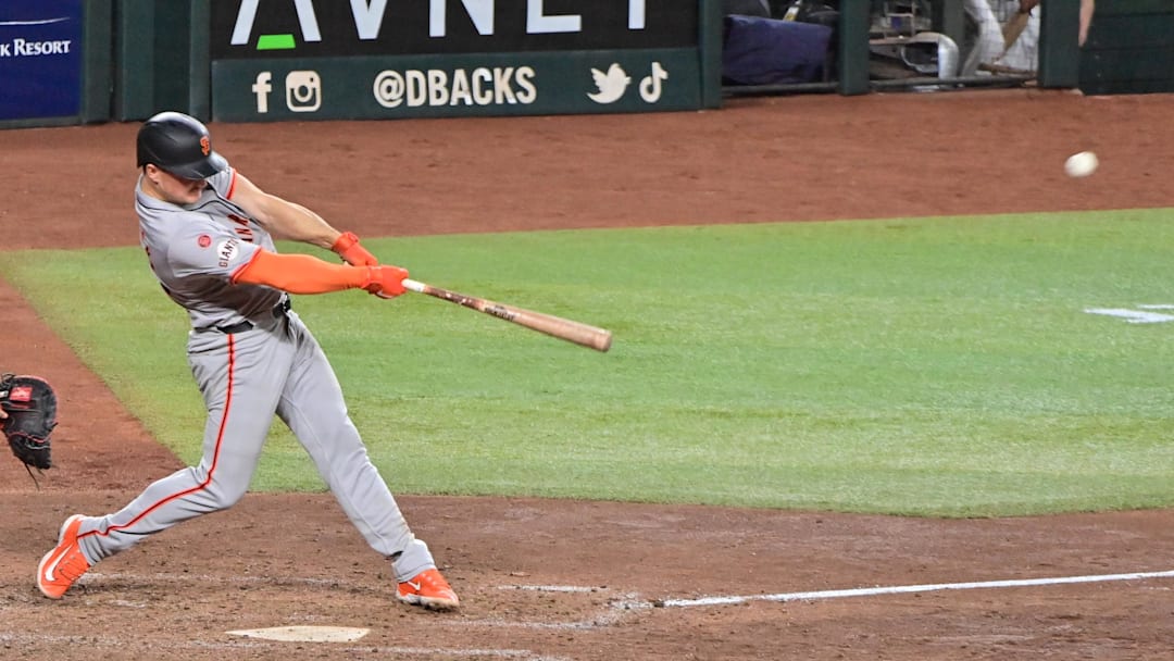 Sep 23, 2024; Phoenix, Arizona, USA;  San Francisco Giants third base Matt Chapman (26) hits a RBI triple in the seventh inning against the Arizona Diamondbacks at Chase Field.