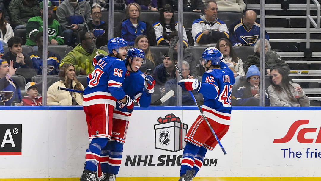 Dec 18, 2025; St. Louis, Missouri, USA; New York Rangers right wing Gabe Perreault (94) celebrates with left wing Will Cuylle (50) and center Noah Laba (42) after scoring his first NHL goal during the second period against the St. Louis Blues at Enterprise Center. Mandatory Credit: Jeff Curry-Imagn Images