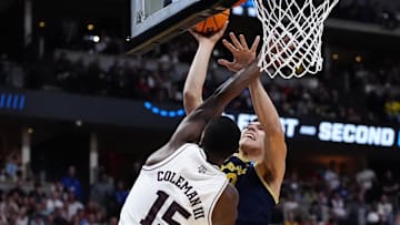 Mar 22, 2025; Denver, CO, USA; Michigan Wolverines center Vladislav Goldin (50) attempts to shoot the ball against Texas A&M Aggies forward Henry Coleman III (15) during the second half in the second round of the NCAA Tournament  at Ball Arena. Mandatory Credit: Ron Chenoy-Imagn Images