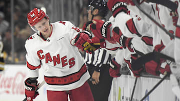 Apr 9, 2024; Boston, Massachusetts, USA; Carolina Hurricanes center Jake Guentzel (59) is congratulated by his teammates after scoring a goal during the third period against the Boston Bruins at TD Garden. Mandatory Credit: Bob DeChiara-Imagn Images