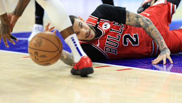 Feb 24, 2025; Philadelphia, Pennsylvania, USA; Chicago Bulls guard Lonzo Ball (2) reaches for a loose ball against the Philadelphia 76ers during the first quarter at Wells Fargo Center. Mandatory Credit: Bill Streicher-Imagn Images