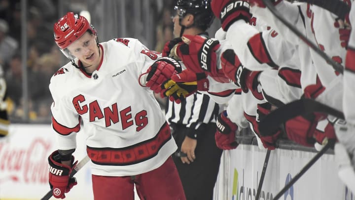 Apr 9, 2024; Boston, Massachusetts, USA; Carolina Hurricanes center Jake Guentzel (59) is congratulated by his teammates after scoring a goal during the third period against the Boston Bruins at TD Garden. Mandatory Credit: Bob DeChiara-USA TODAY Sports