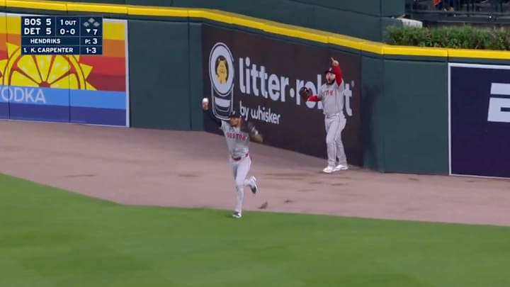 Red Sox outfielders Rafaela and Abreu celebrate a robbed home run. Red Sox outfielders Rafaela and Abreu celebrate a robbed home run.