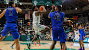 Jan 30, 2025; New Orleans, Louisiana, USA;  Tulane Green Wave forward Kaleb Banks (1) drives to the basket against Memphis Tigers forward Dain Dainja (42) during the second half at Avron B. Fogelman Arena in Devlin Fieldhouse. 