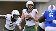 Sep 6, 2025; Dallas, Texas, USA; Baylor Bears quarterback Sawyer Robertson (13) looks to pass the ball against the SMU Mustangs during the second quarter at Gerald J. Ford Stadium. Mandatory Credit: Jerome Miron-Imagn Images