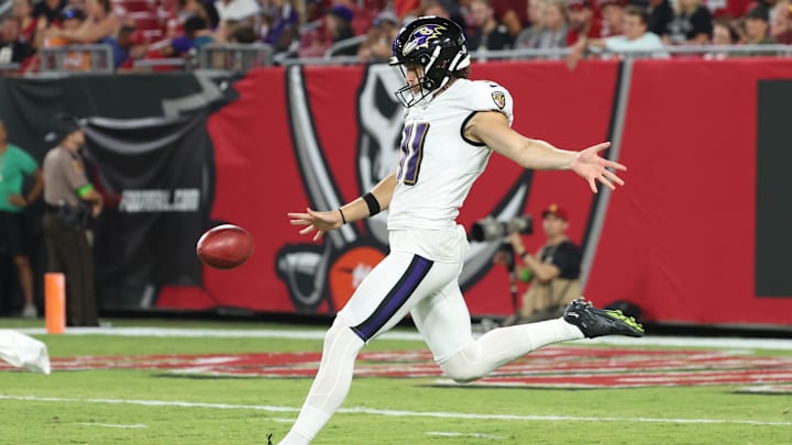 Aug 26, 2023; Tampa, Florida, USA; Baltimore Ravens punter Jordan Stout (11) punts the ball against the Tampa Bay Buccaneers during the second quarter at Raymond James Stadium. Mandatory Credit: Kim Klement Neitzel-Imagn Images