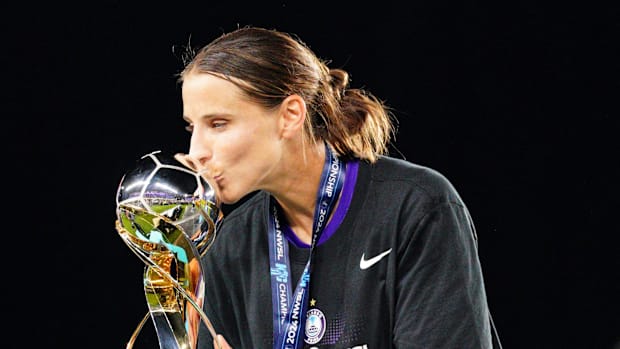 Orlando Pride defender Kylie Strom kisses the NWSL Championship trophy in Kansas City in 2024.
