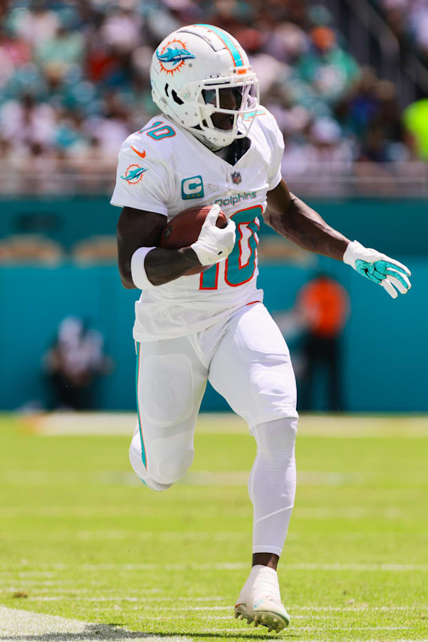 Miami Dolphins wide receiver Tyreek Hill runs with the football against the Jacksonville Jaguars