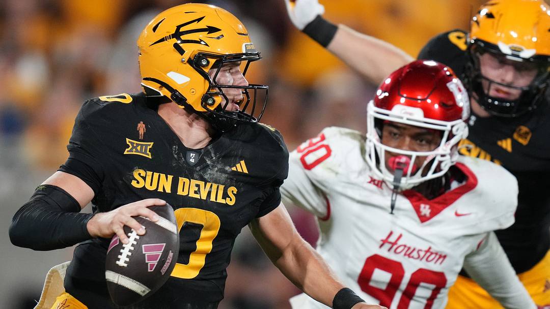 ASU Sun Devils quarterback Sam Leavitt (10) scrambles away from Houston Cougars defensive lineman Eddie Walls III (90) at Mountain America Stadium in Tempe on Oct. 25, 2025.
