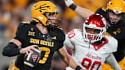 ASU Sun Devils quarterback Sam Leavitt (10) scrambles away from Houston Cougars defensive lineman Eddie Walls III (90) at Mountain America Stadium in Tempe on Oct. 25, 2025.