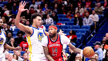 Nov 22, 2024; New Orleans, Louisiana, USA;  New Orleans Pelicans forward Brandon Ingram (14) dribbles against Golden State Warriors forward Trayce Jackson-Davis (32) during first half at Smoothie King Center. Mandatory Credit: Stephen Lew-Imagn Images
