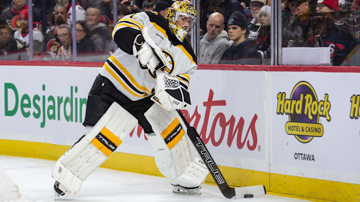 Jan 18, 2025; Ottawa, Ontario, CAN; Boston Bruins goalie Jeremy Swayman (1) moves the puck in the first period against the Ottawa Senators at the Canadian Tire Centre. Mandatory Credit: Marc DesRosiers-Imagn Images