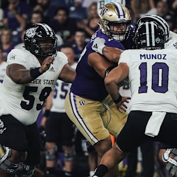 Sebastian Valdez (50) and Zach Durfee (5) put the pressure on Weber State quarterback Richie Munoz. 