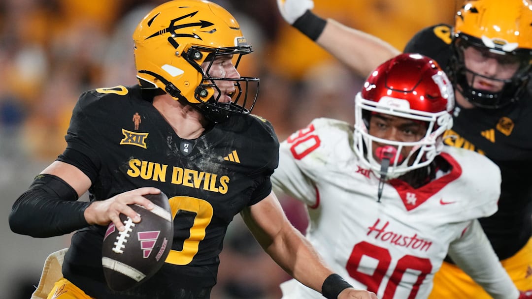 ASU Sun Devils quarterback Sam Leavitt (10) scrambles away from Houston Cougars defensive lineman Eddie Walls III (90) at Mountain America Stadium in Tempe on Oct. 25, 2025.