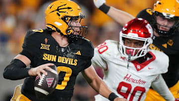 ASU Sun Devils quarterback Sam Leavitt (10) scrambles away from Houston Cougars defensive lineman Eddie Walls III (90) at Mountain America Stadium in Tempe on Oct. 25, 2025.